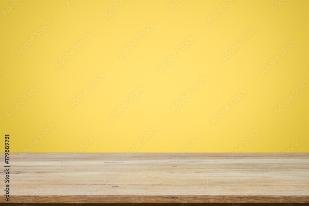 Empty wooden deck table over yellow wallpaper background. Empty wooden deck table over yellow wallpaper background.