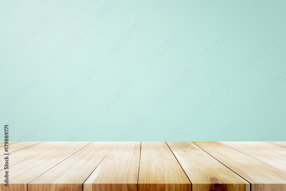 Empty wooden deck table over mint wallpaper background. - obrazy, fototapety, plakaty 