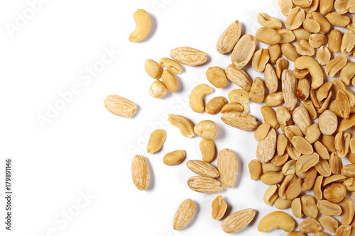 Mix of roasted and salted peanuts, cashew nuts, almonds and hazelnut isolated on white background, top view
