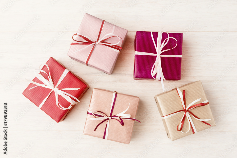 Various gift boxes over light wooden background Various gift boxes over light wooden background