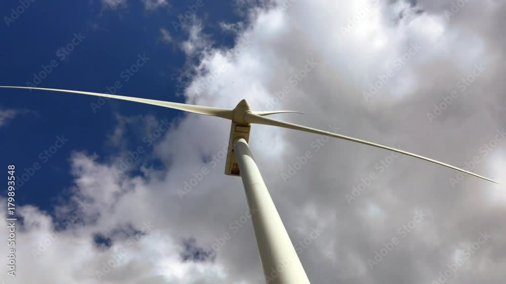 Working wind turbine video. Blue sky with clouds background Working wind turbine video. Blue sky with clouds background
