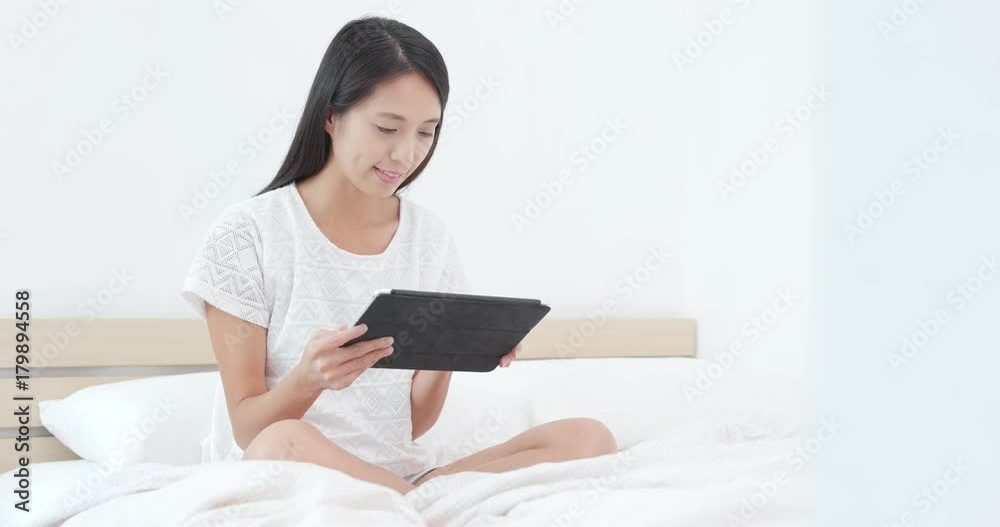 Woman posting on social media with tablet computer Woman posting on social media with tablet computer