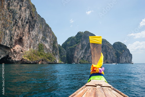 Traditional Thai Longtail boat and island of Phi Phi Leh on the horizon,Thailand © arbalest