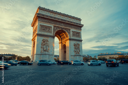 Canvas Print Famous Paris avenue Champs-Elysees and the Triumphal Arch, symbol of the glory on bright sunny day with cloudy sky