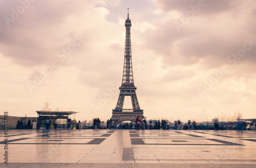 Eiffel tower, Paris symbol and iconic landmark in France, on a cloudy day. Famous touristic places and romantic travel destinations in Europe. Cityscape and tourism concept. Long exposure. Toned © sergiymolchenko