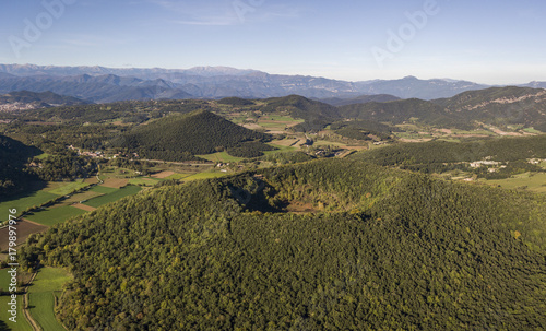 Aerial view of Garrotxa Volcanic Zone Natural Park and Santa Margarida Volcano in the foreground photo