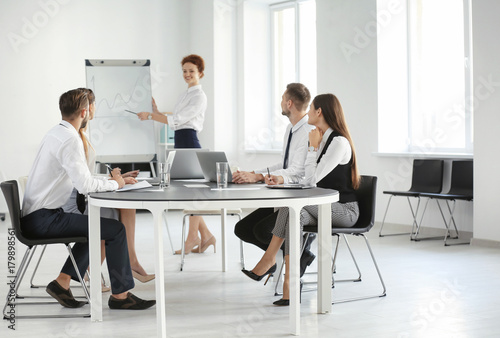 Team of young professionals conducting business meeting in office