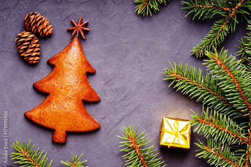 Christmas handmade cookie of fir tree shape, spice and festive decor