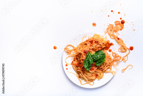 Italian pasta on a plate, spaghetti cooked with tomato sauce.