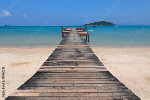 Old wooden pier on exotic beach island