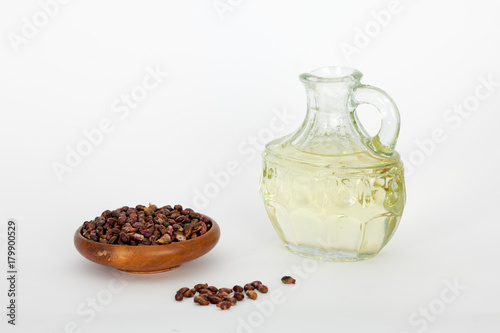 Grape seed in wooden bowl and grape seed oil in glass jar. Antioxidant, healthy seed oil.