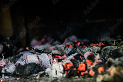 Hot coal, embers of the grill and smoke close up