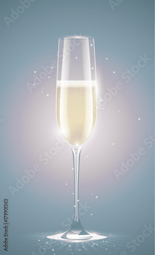 Transparent champagne glass with sparkling white wine. Faded retro vintage background. New Year or other event greeting card with sparks.