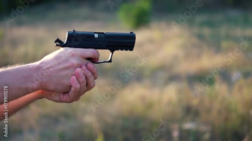 Gun shot in slow motion with sound of a shot.