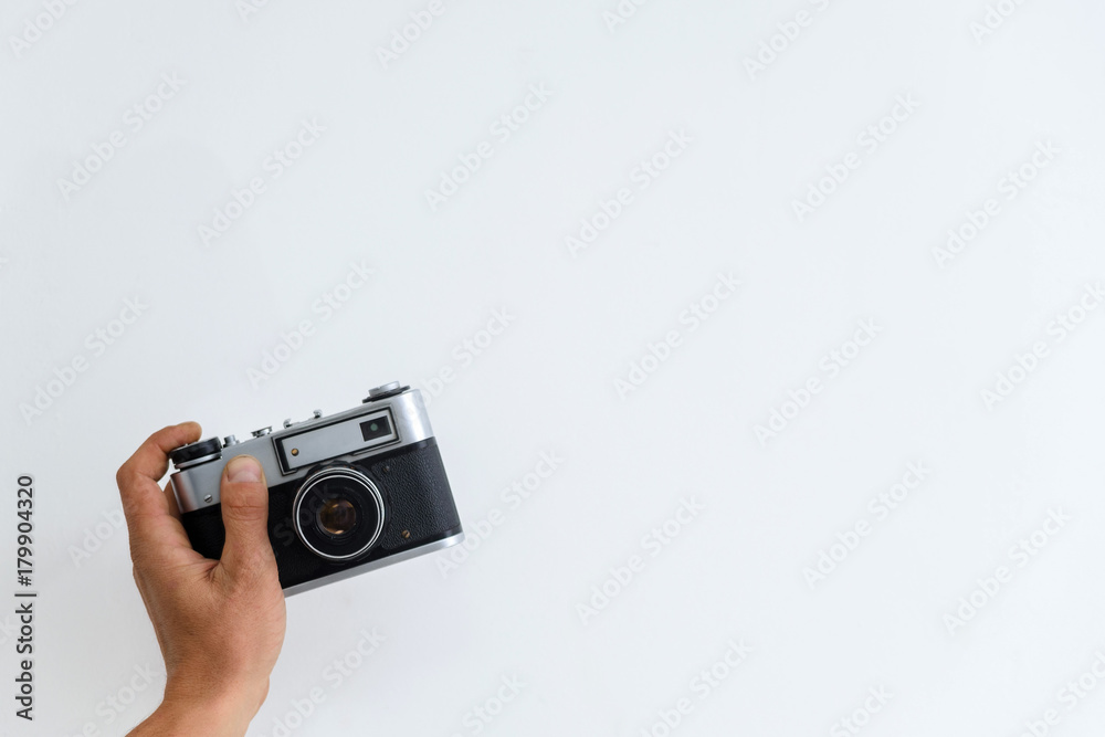 camera in hand on a white background camera in hand on a white background