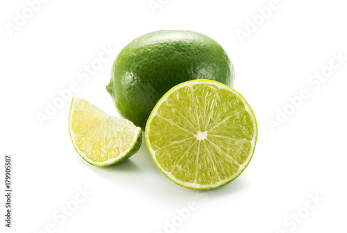 Limes with slices isolated on white background