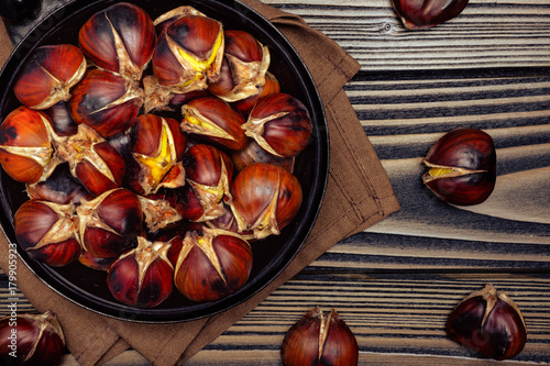 chestnuts in a pan on wooden background