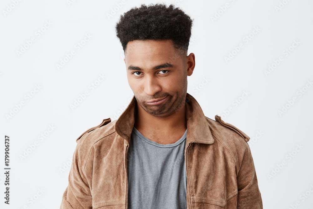 Damn man. Close up of young funny black-skinned man with afro hairstyle in  casual fashionable clothes looking in camera with silly face expression,  having fun, playing with little kid. Stock Photo |