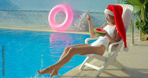 Christmas Woman eating watermelon at the Pool