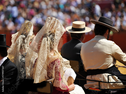Andalusian women with mantilla in a horse carriage, Spain photo