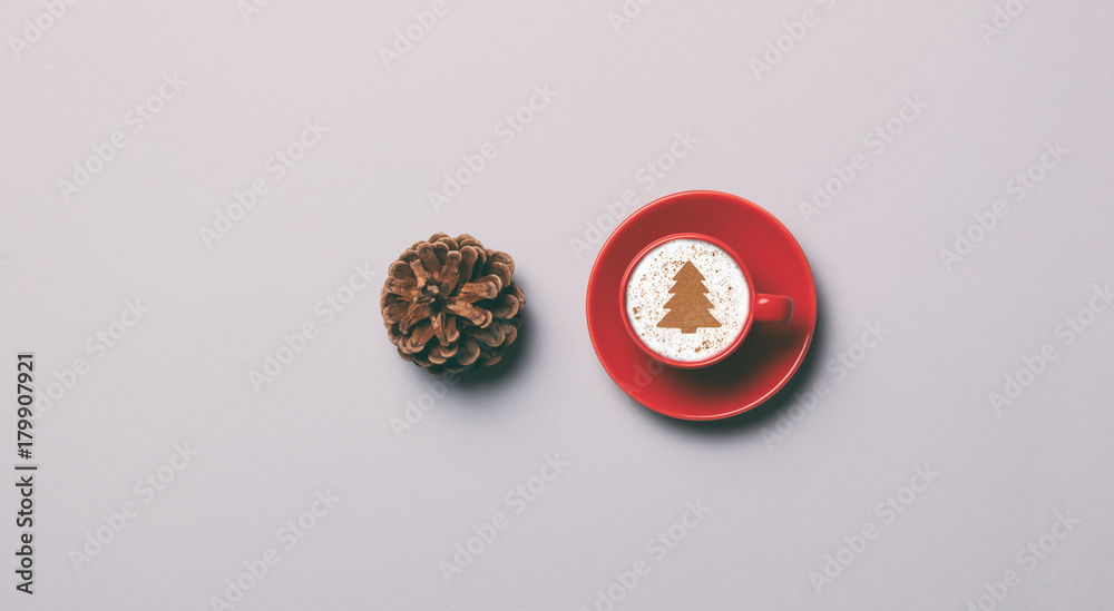 Red cup of coffee and pine cone Red cup of coffee and pine cone