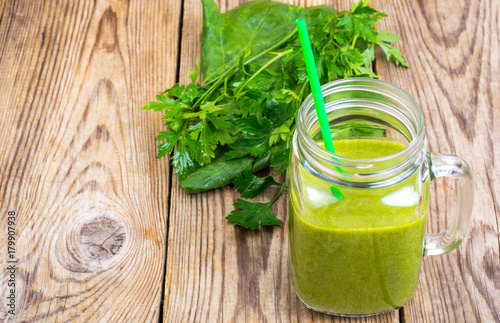 Healthy green smoothie with straw in jar