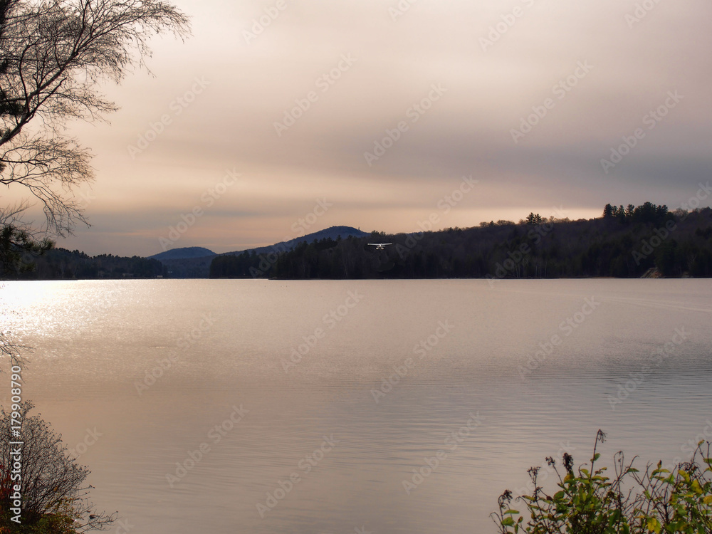 Fototapeta premium Seaplane taking off at sundown