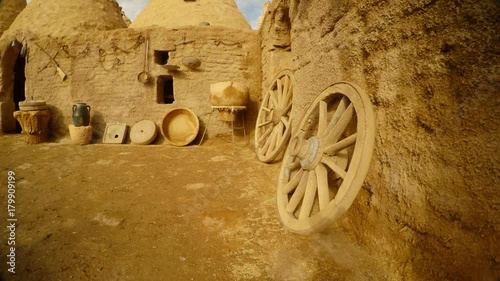 wooden wheels, old utensils and clay house in the Arab village, near the border between Turkey and Syria