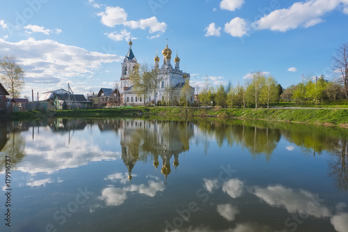 Landscape with an Orthodox church on the shore of the pond on the May day. The Church of the Intercession of the Blessed Virgin Mary in the village of Zhestylevo, Dmitrovsky District, Moscow Region