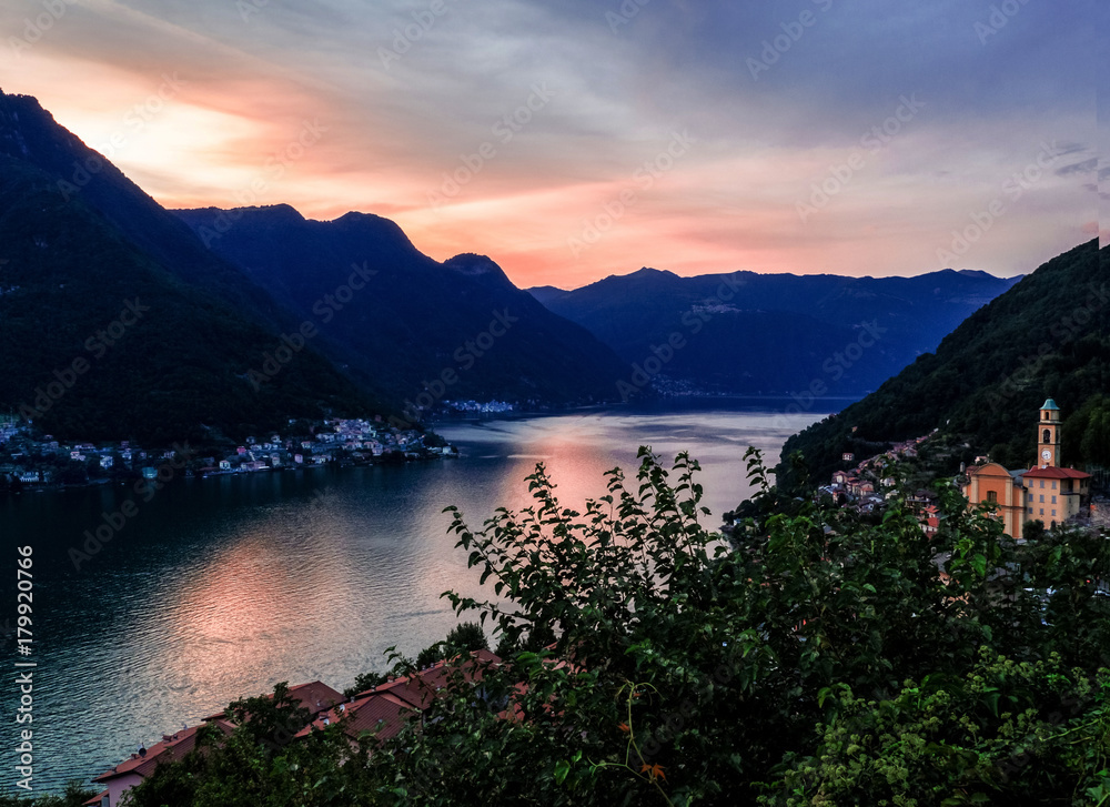 small countries shine in the light of a romantic sunset over lake como, italy
