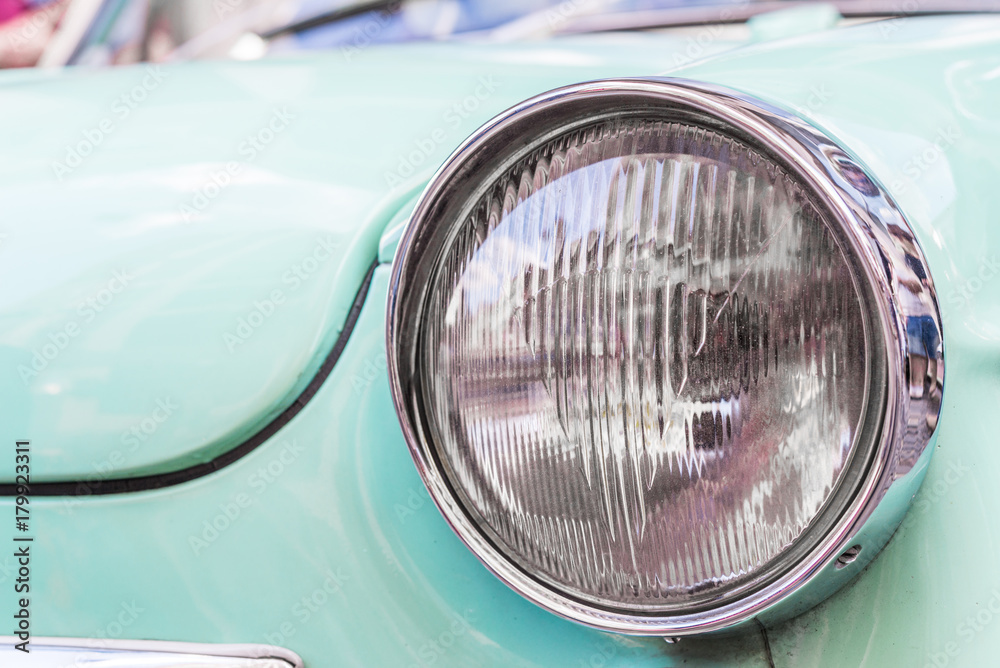 Headlight of a vintage retro old car automobile vehicle