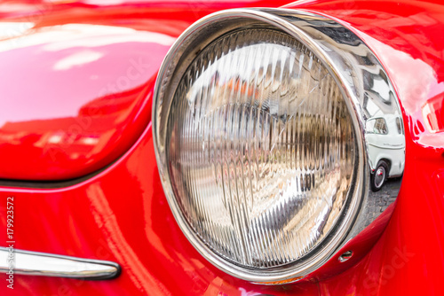 Headlight of a vintage retro old car automobile vehicle