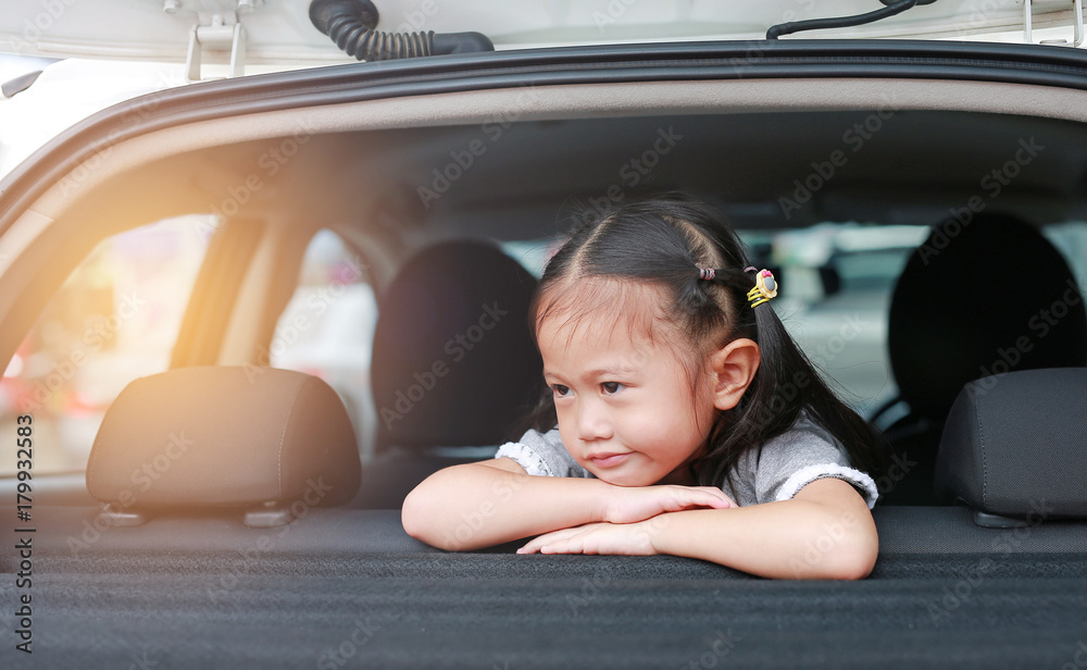 Happy little asian child looking out from the window of the car. Happy little asian child looking out from the window of the car.