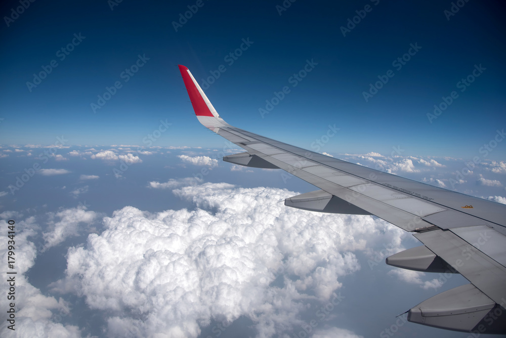 Clouds and sky as seen through window of an aircraft Clouds and sky as seen through window of an aircraft