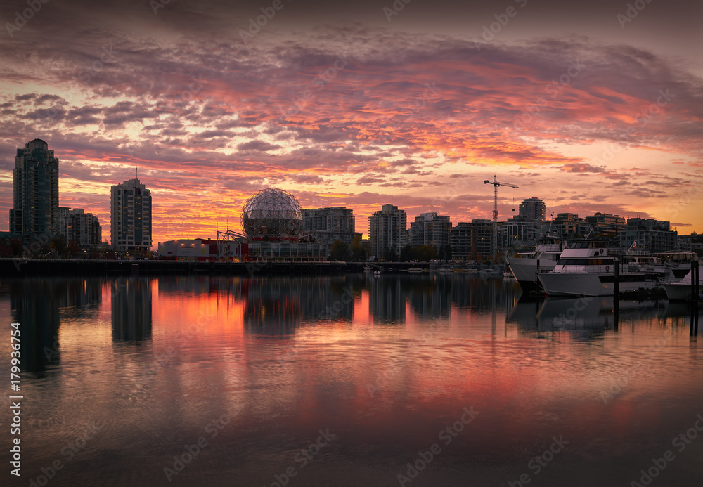 False Creek Sunrise, Vancouver. Sunrise on the Vancouver skyline on the edge of False Creek including condominium towers and the geodesic dome of Science World. British Columbia, Canada.

