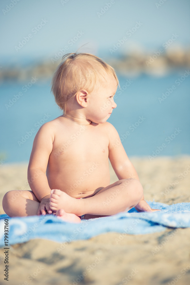 Baby playing with toys on the sandy beach near the sea. Cute little kid in sand on tropical beach. Ocean coast. Baby playing with toys on the sandy beach near the sea. Cute little kid in sand on tropical beach. Ocean coast.