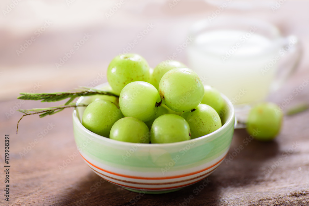 Indian gooseberry fruit and juice on wooden background,healthy food Indian gooseberry fruit and juice on wooden background,healthy food