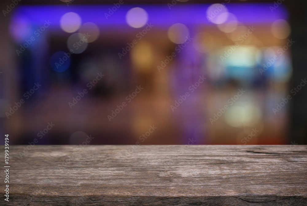 Empty dark wooden table in front of abstract blurred bokeh background of restaurant . can be used for display or montage your products.Mock up for space. Empty dark wooden table in front of abstract blurred bokeh background of restaurant . can be used for display or montage your products.Mock up for space.