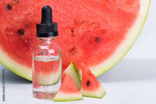 concentrate of watermelon flavor in a bottle, next to it