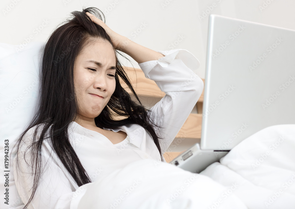beautiful Asian strain for working in laptop with in the morning on bed beautiful Asian strain for working in laptop with in the morning on bed
