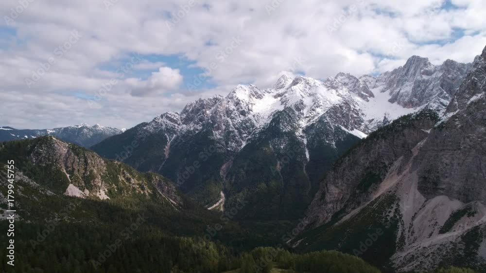Vrisic Pass snow covered mountain peaks with cloudy sky in aerial view Vrisic Pass snow covered mountain peaks with cloudy sky in aerial view