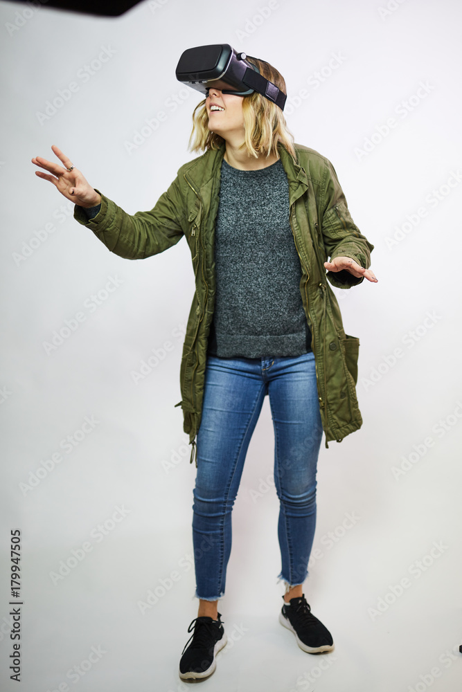 young woman wearing virtual reality goggles white background young woman wearing virtual reality goggles white background
