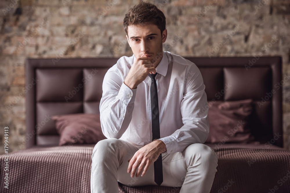 Handsome businessman in bedroom