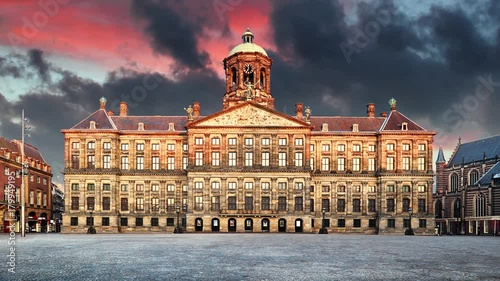 Royal Palace on the dam square in Amsterdam, Netherlands, Time lapse at sunset. photo