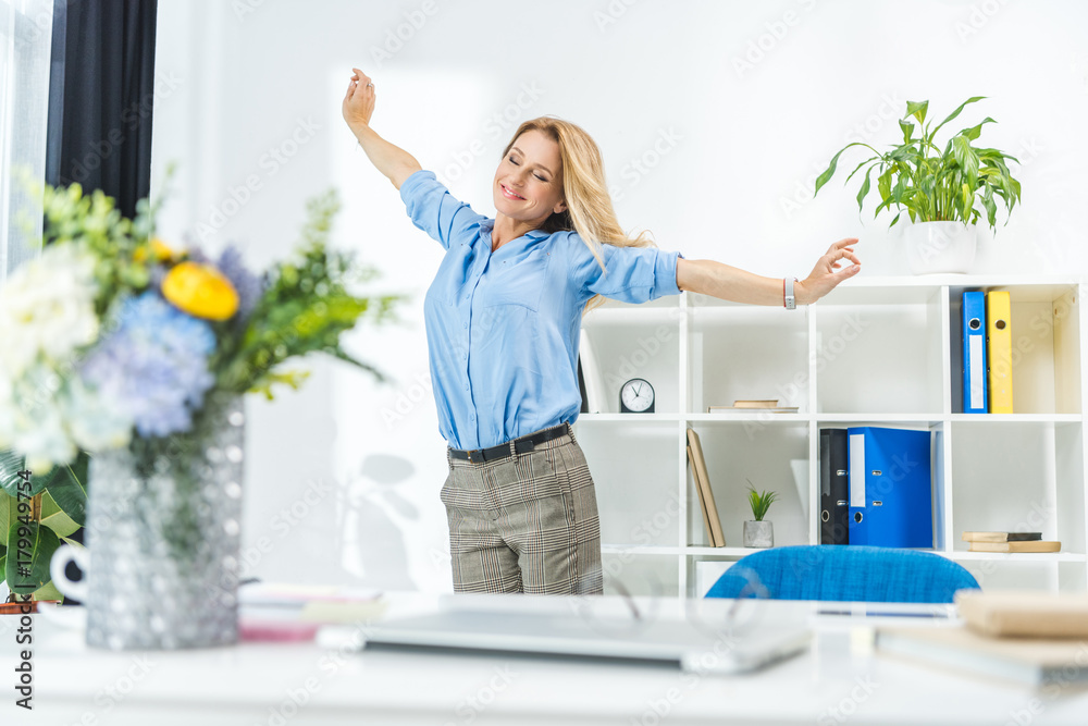 businesswoman stretching in modern office businesswoman stretching in modern office