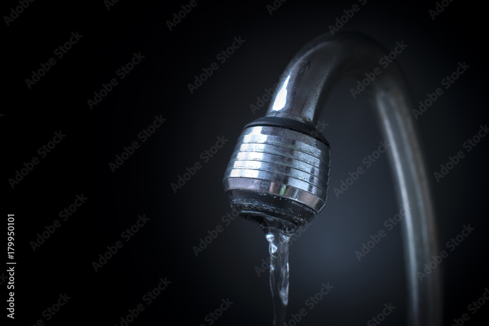 closeup water flowing from opened faucet closeup water flowing from opened faucet