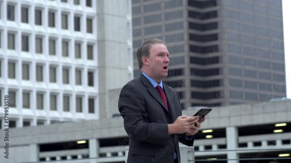 Businessman reads exciting news on tablet and celebrates Businessman reads exciting news on tablet and celebrates
