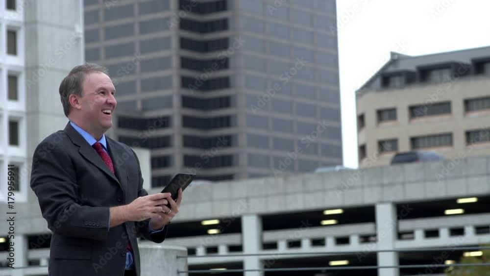 Businessman reads good news on tablet and celebrates Businessman reads good news on tablet and celebrates