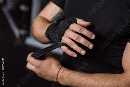 boxer wrapping hand with bandage