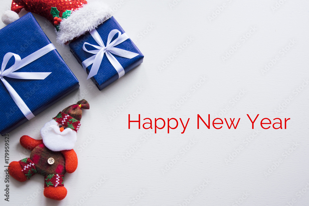 New year's background on a white desk decorated with toys, presents, Santa Claus, snowman. Bright colored background symbolizes the new year celebration. Great useful template to wright words down.